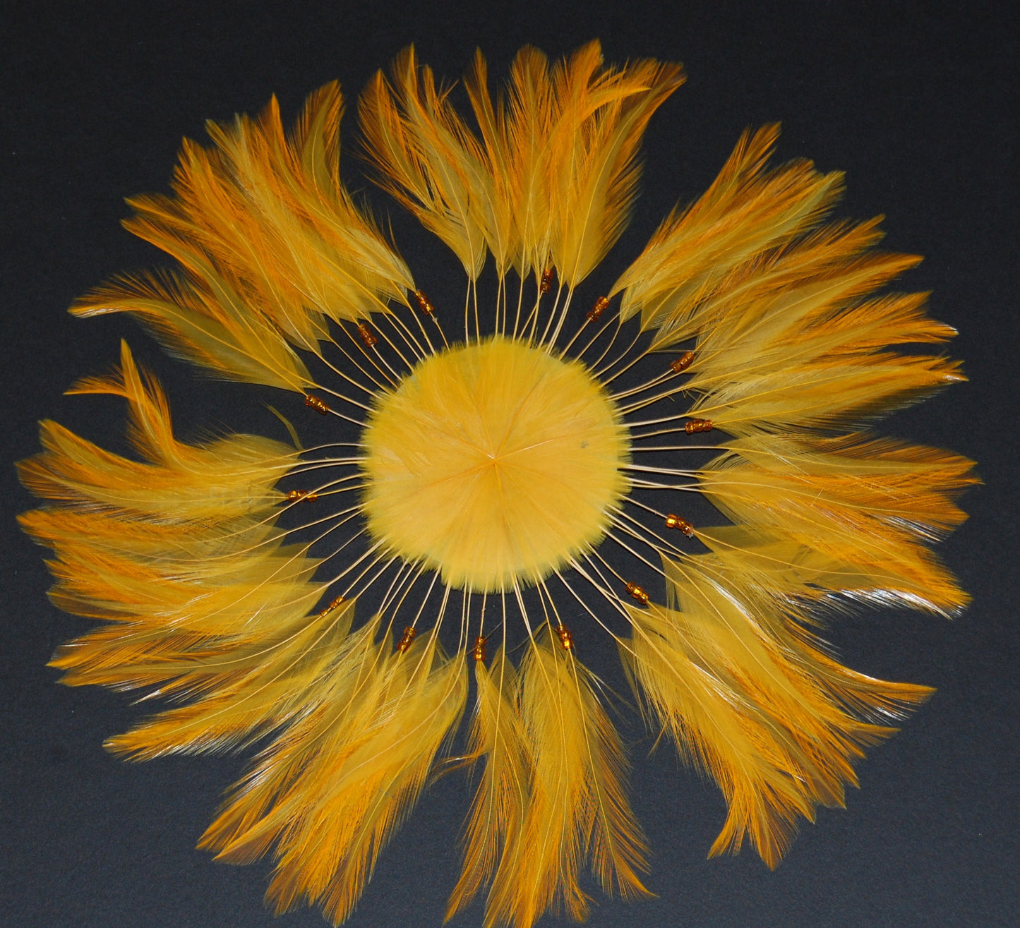 A gold colored feather pinwheel