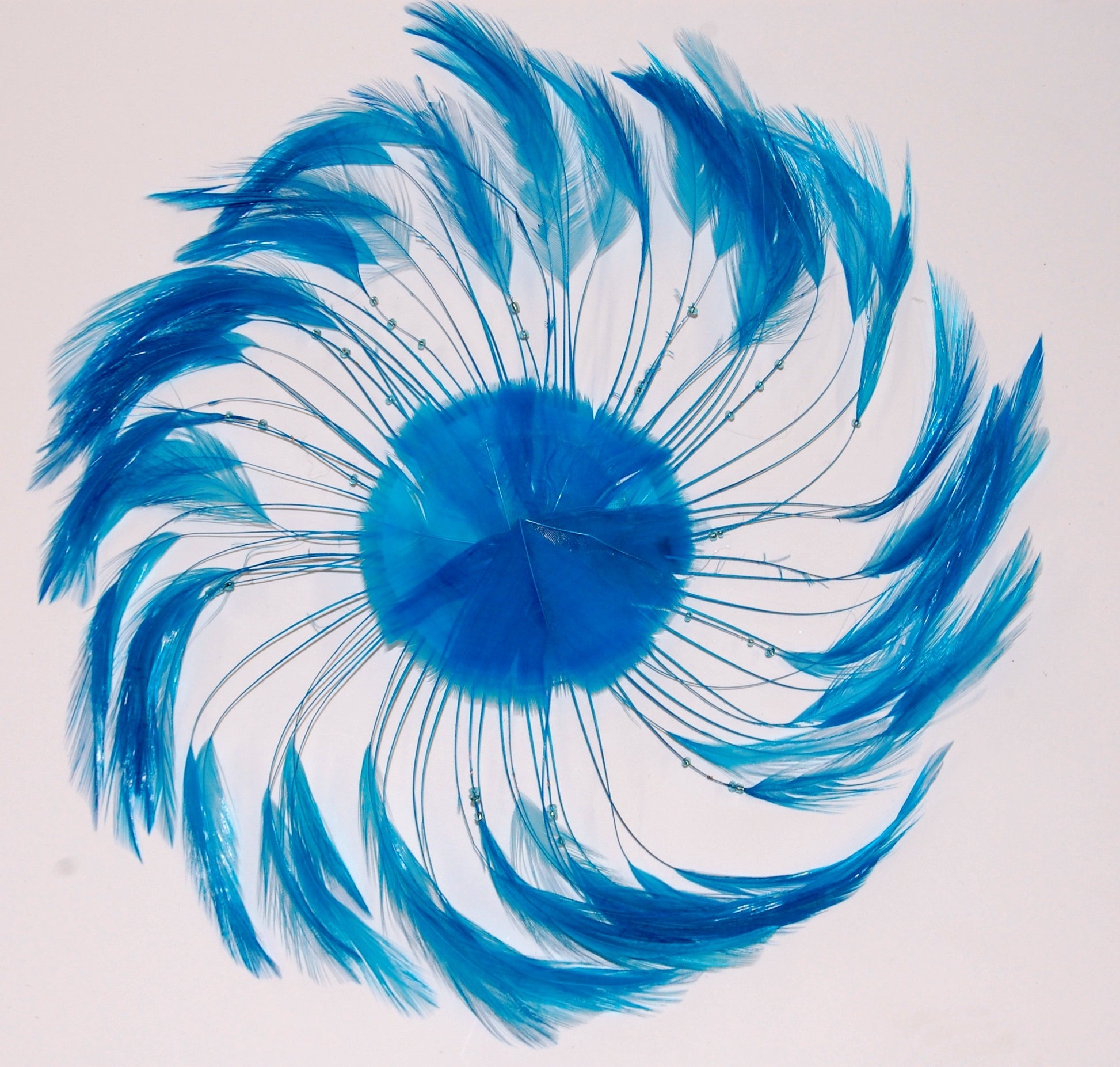 A Turquoise pinwheel on white background