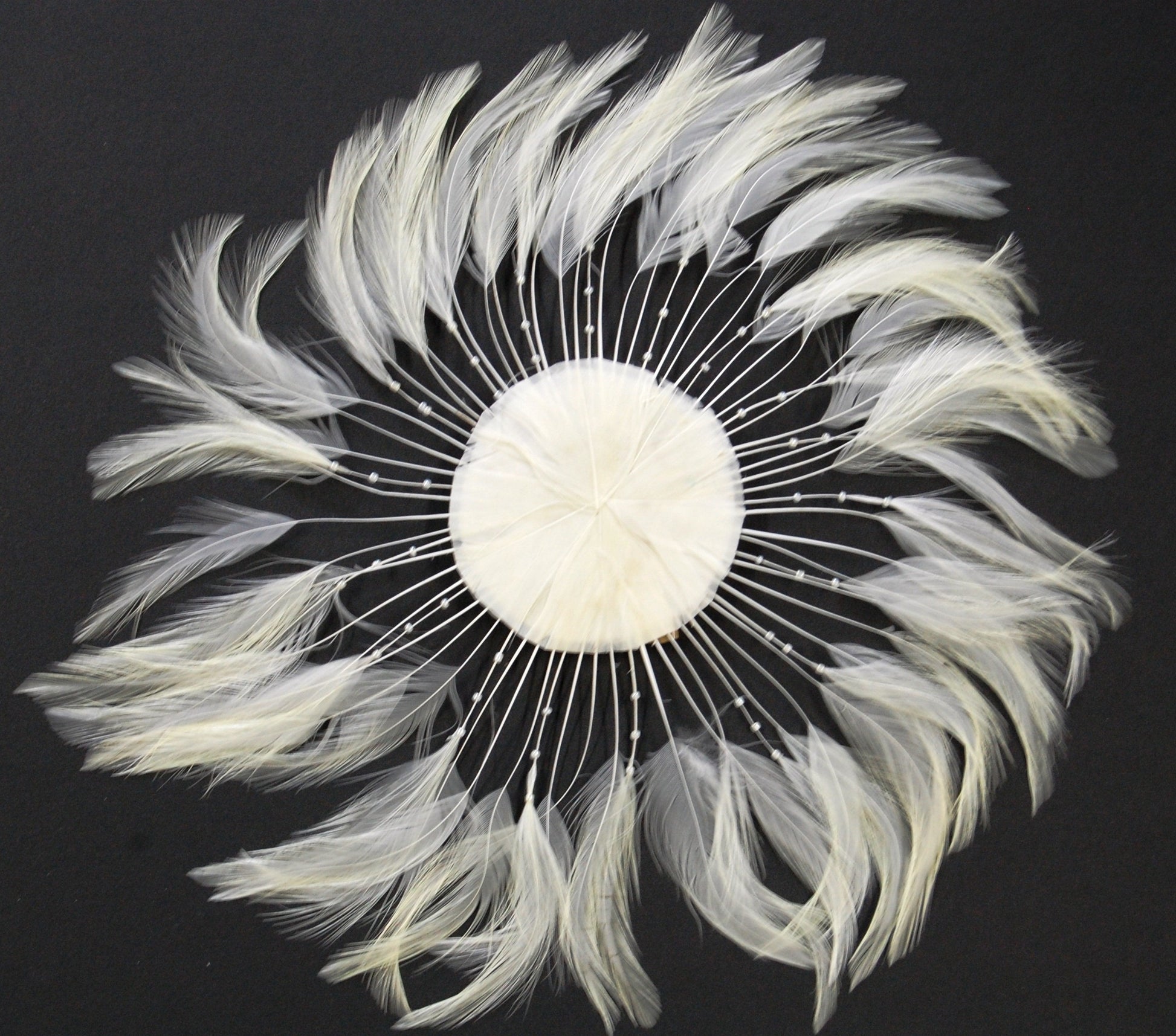 an ivory colored feather pinwheel