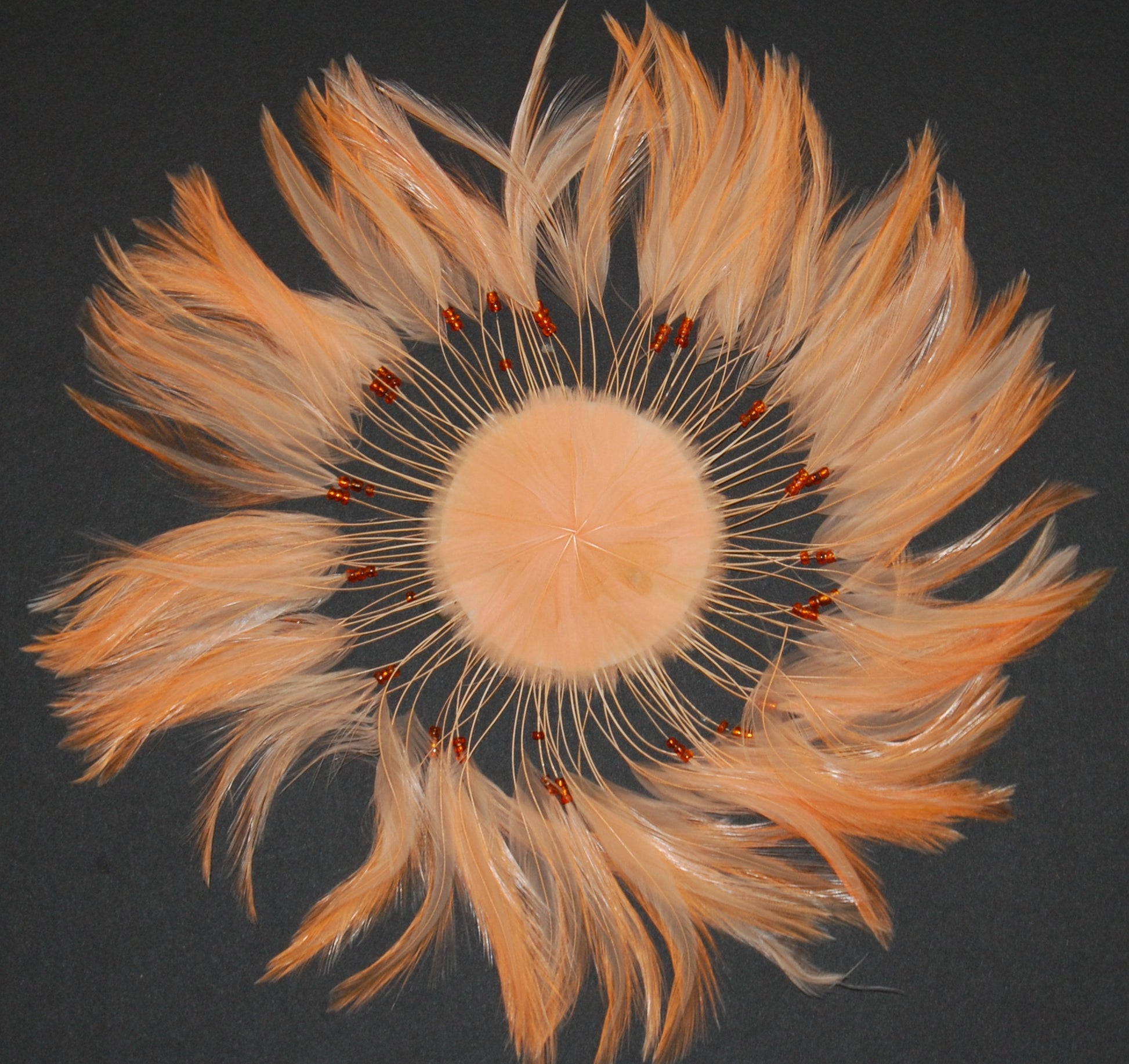 a peach colored feather pinwheel